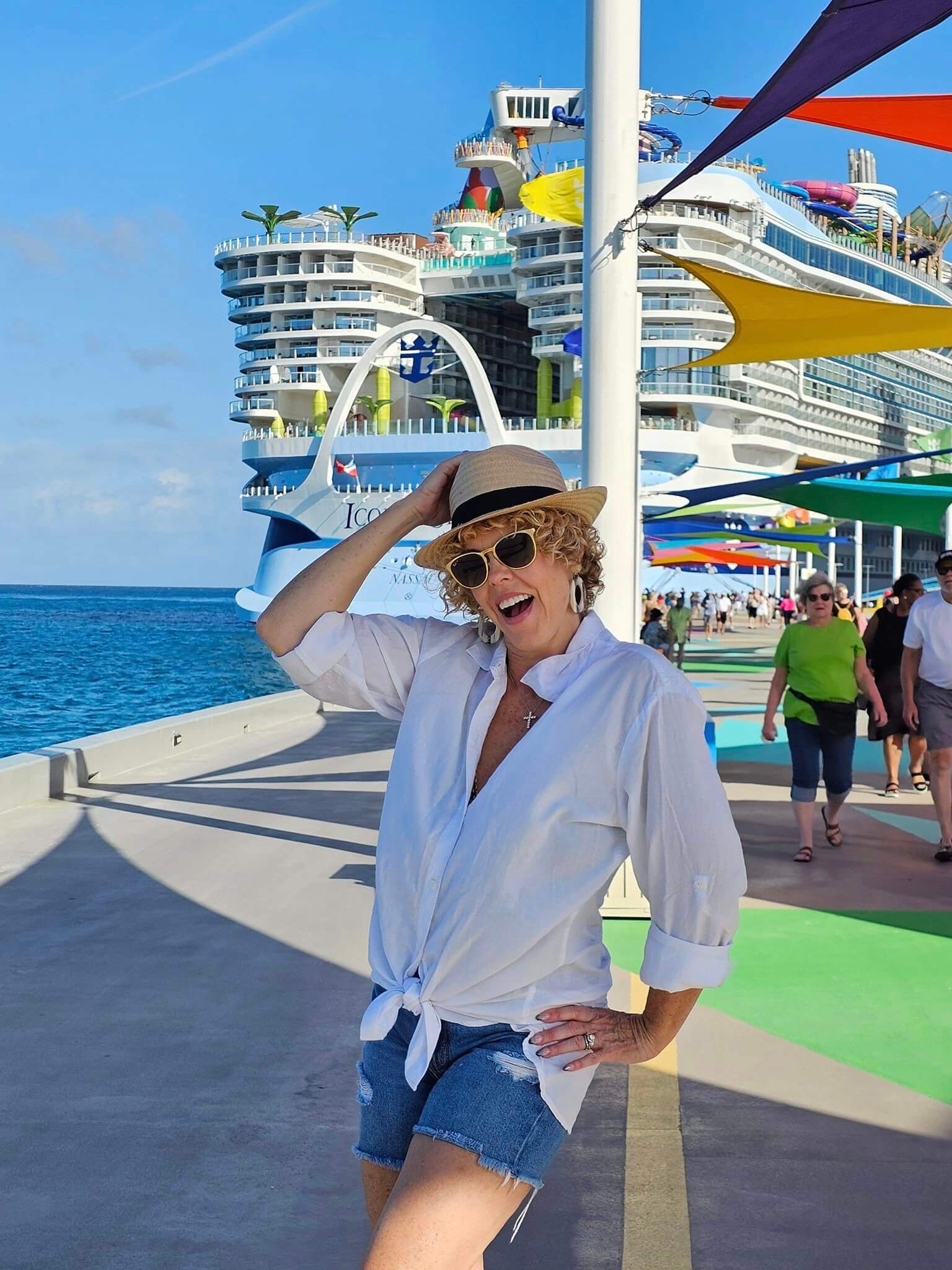 picture of gg standing in front of large Icon of the seas cruise ship, small ship vs mega cruise blog