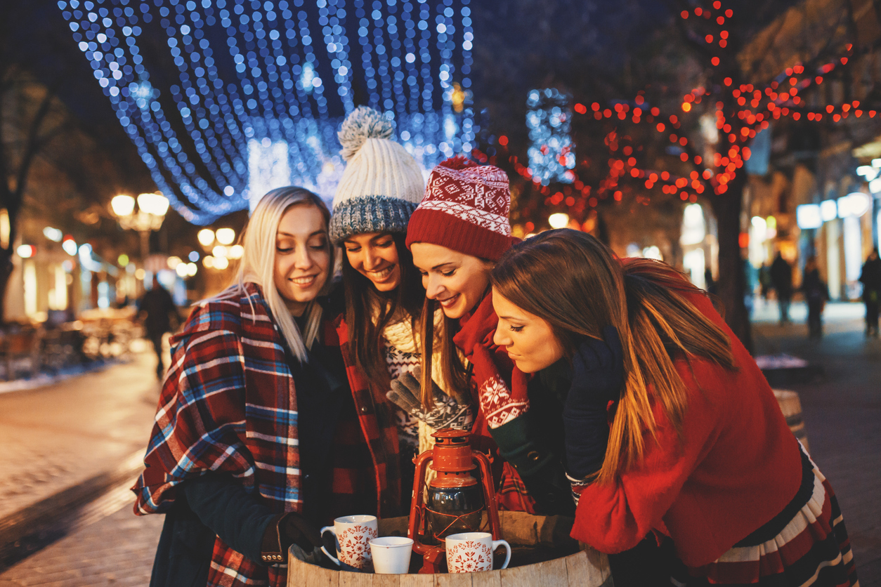 friends at Christmas market drinking cocoa; from blog Celebrity cruises launches into river cruising