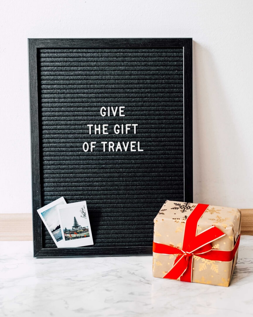 picture that says give the gift of travel; blog post best travel gifts for christmas