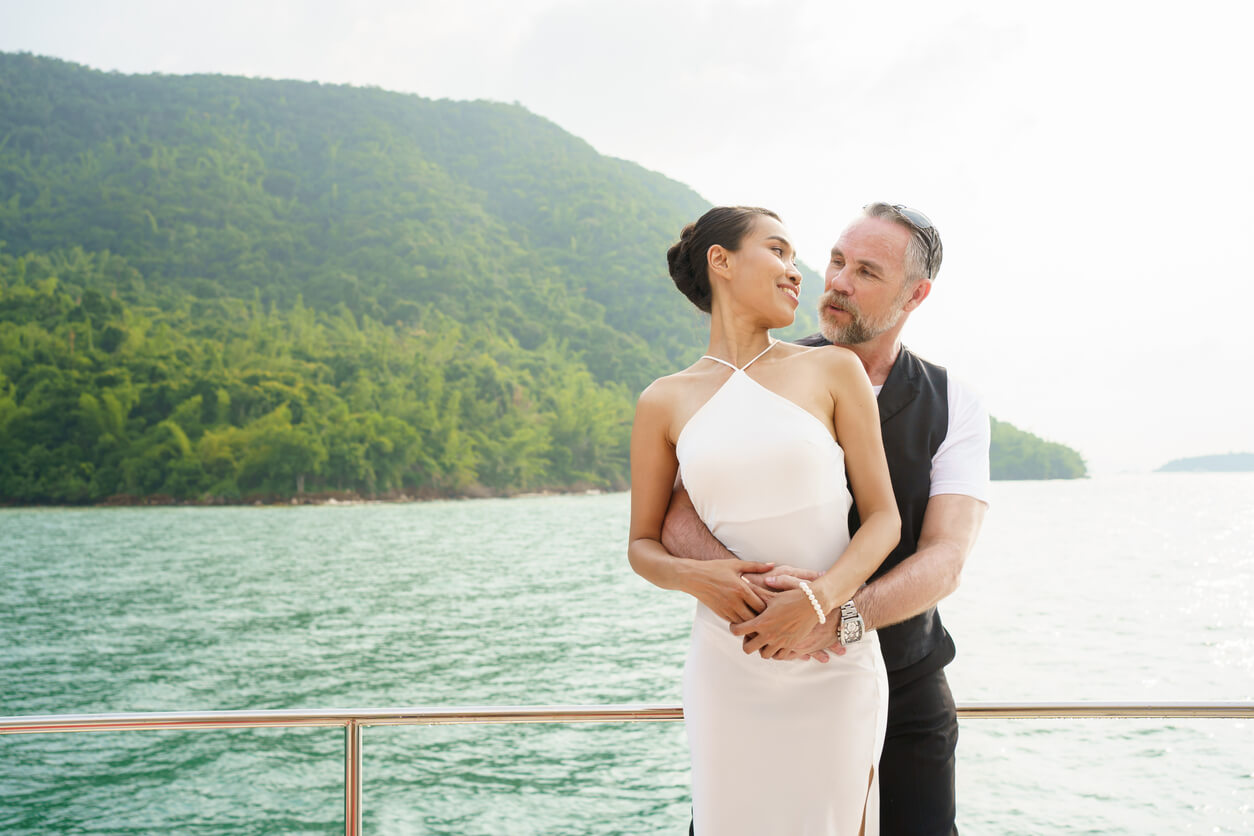 a couple on a ship in wedding attire with the ocean behind them.
from blog post: why a group cruise is the smartest choice for a wedding