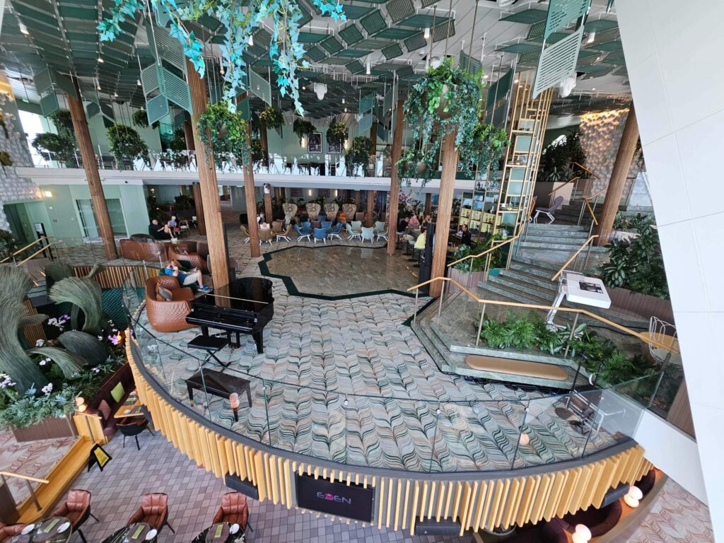 lounge and bar wtih greenery and a green space from blog post: Best Adult Friendly Cruise Line