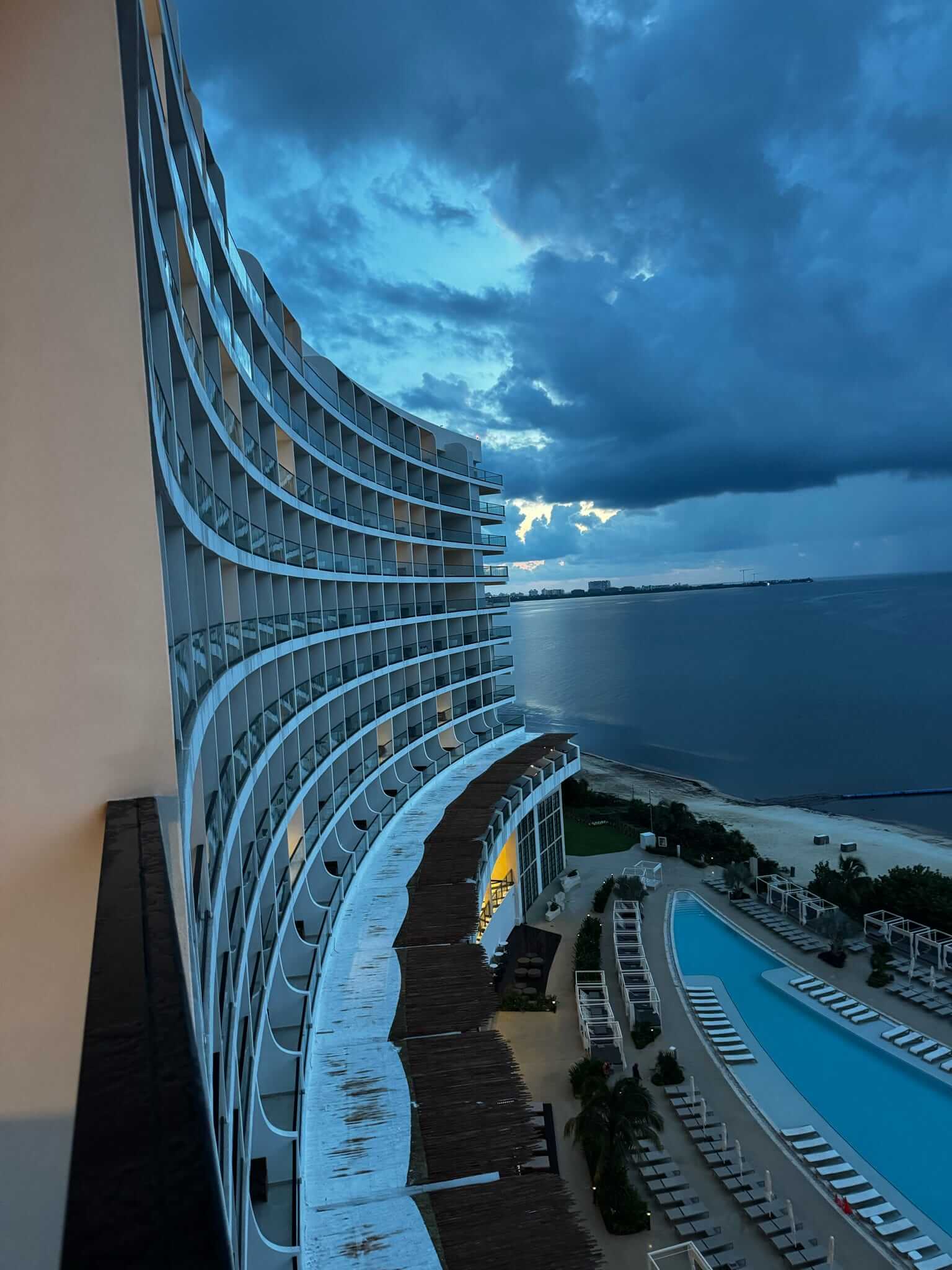 high rise hotel with a pool and ocean; from blog post All Inclusive Resort Corporate Retreats