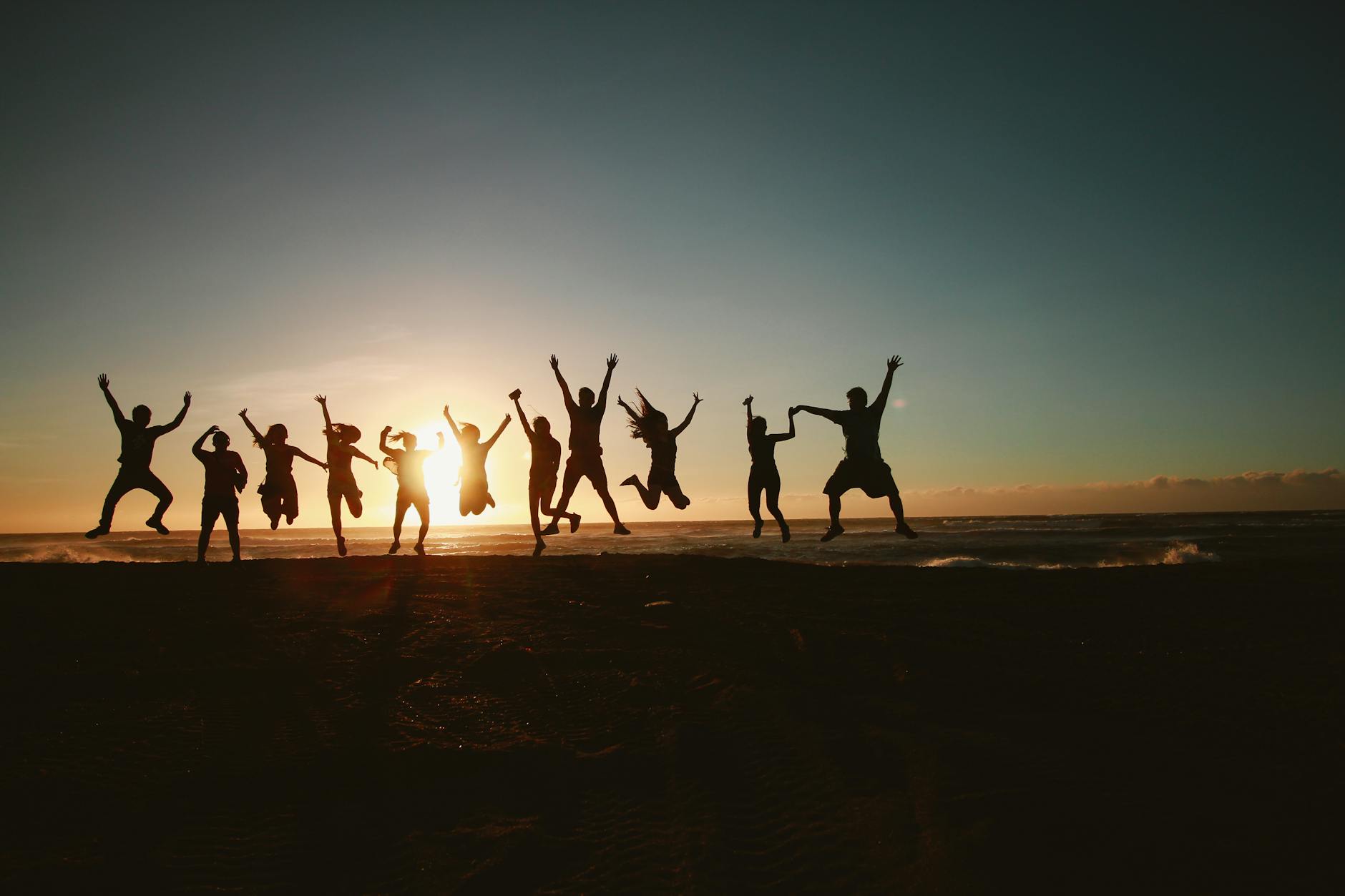 silhouette photography of group of people jumping during golden time from blog post All Inclusive Resort Corporate Retreat 
