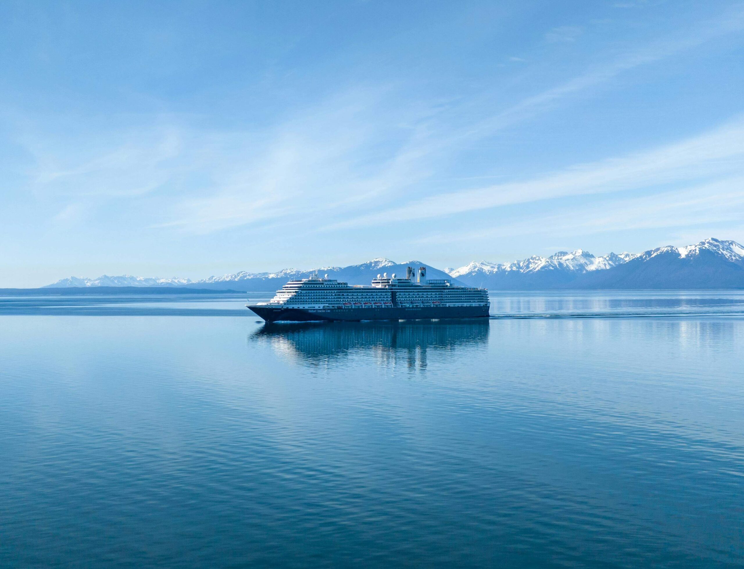 cruise ship on water with snowy mountain in background from blog post Alaska Cruise Guide