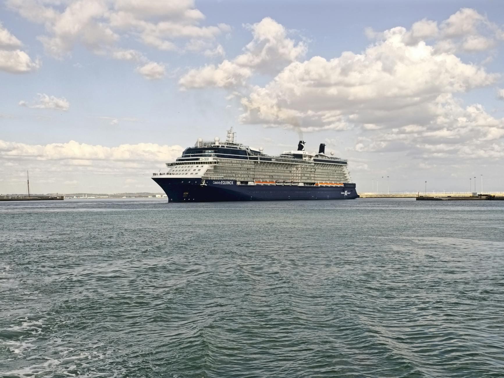 luxury cruise ship docked in spanish harbor from blog post celebrity cruise vs virgin voyages
