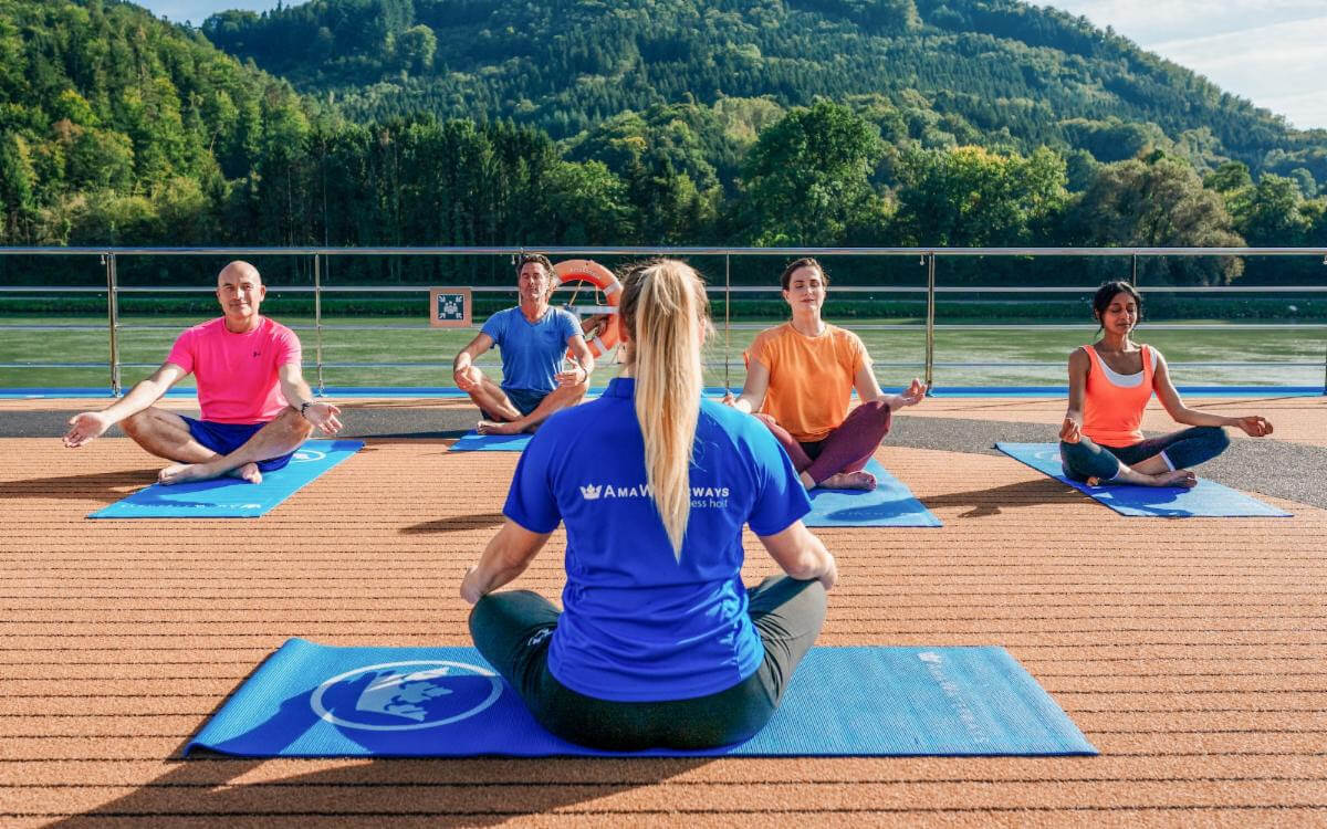 woman leading yoga class on deck of cruise ship from blog post, River cruising in your 30s