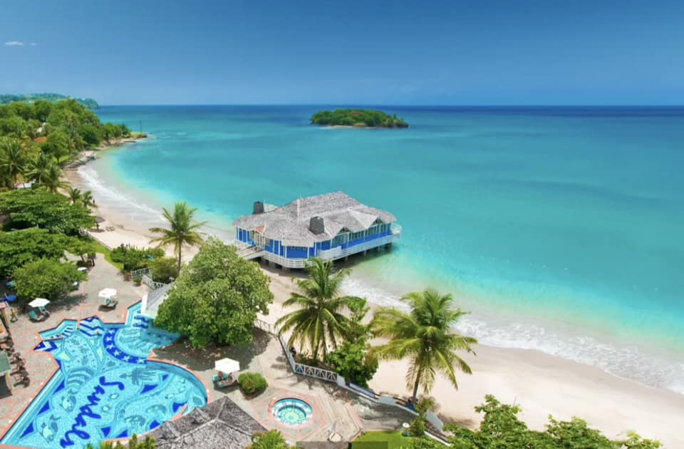 overhead view of Sandals Halcyon in St Lucia;  blue water ocean and beach and pool.  From blog postr Best Sandals resorts