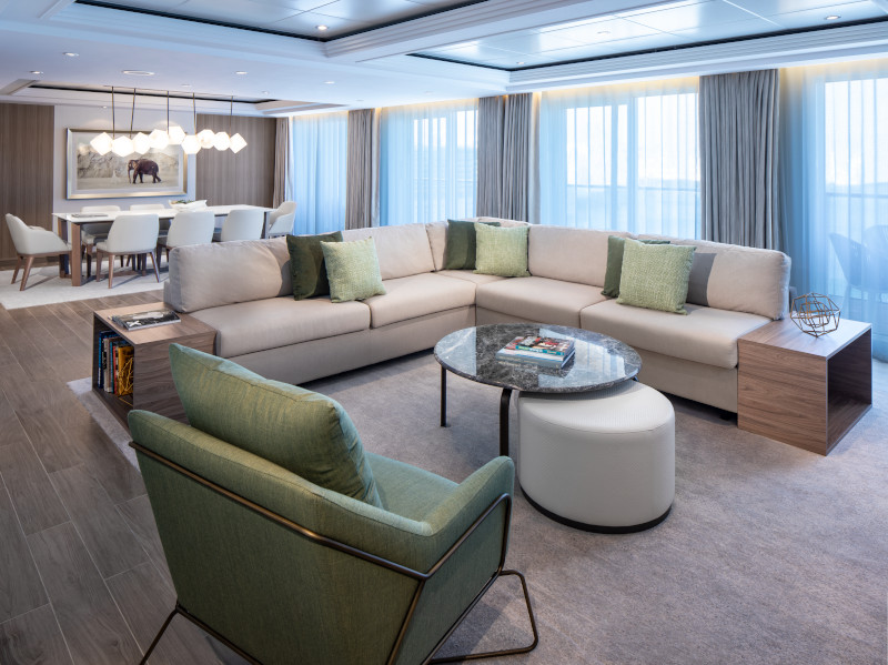 large living room with bedroom in the background on a cruise ship