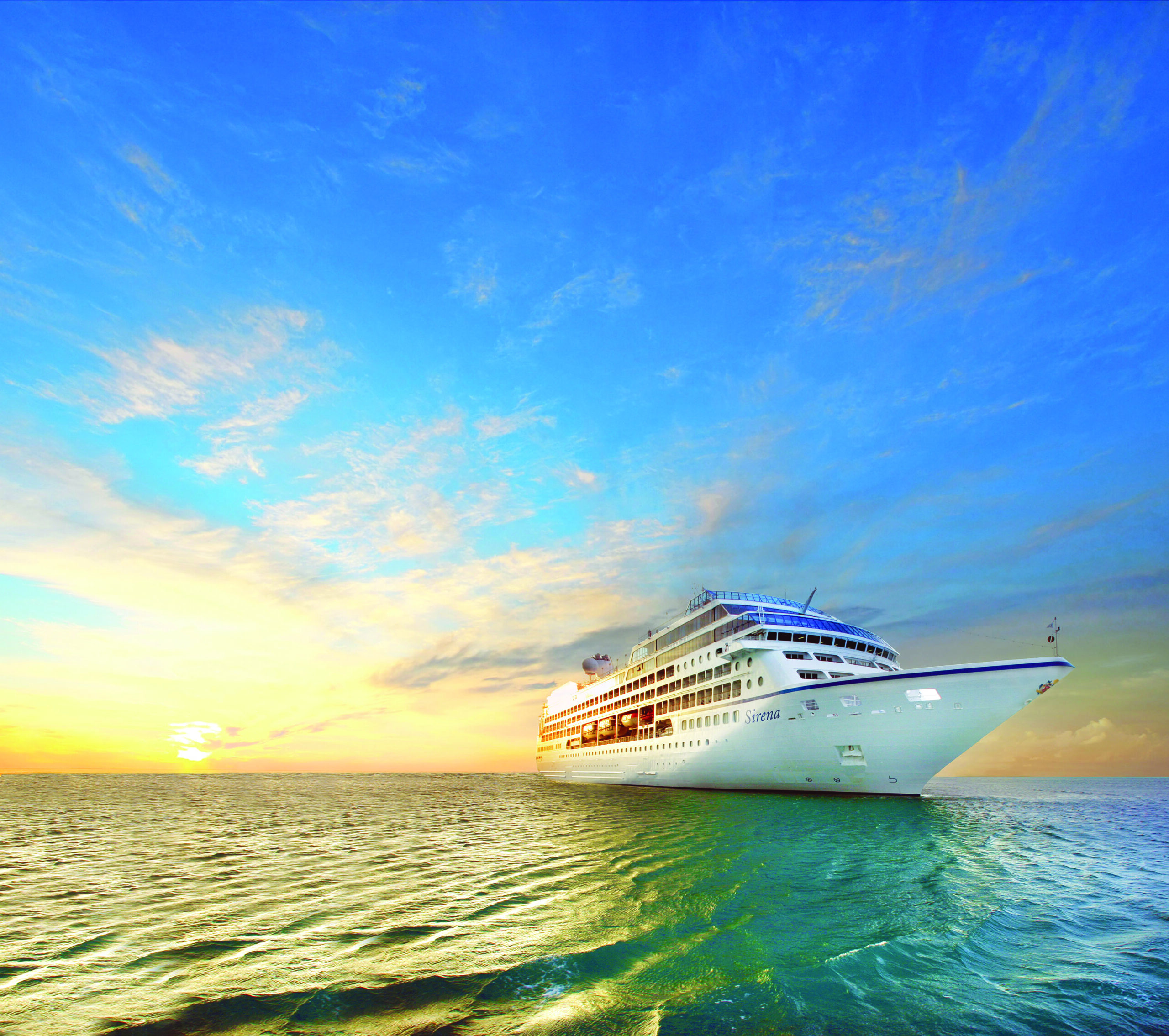 cruise ship on the ocean with sunset in background