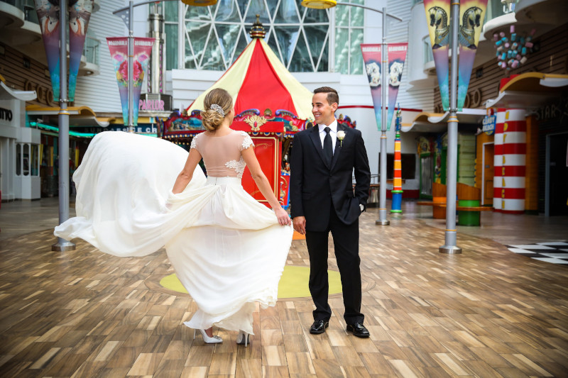 bride spinning around as the groom looks at her